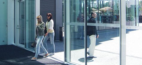 People walking in and out of building