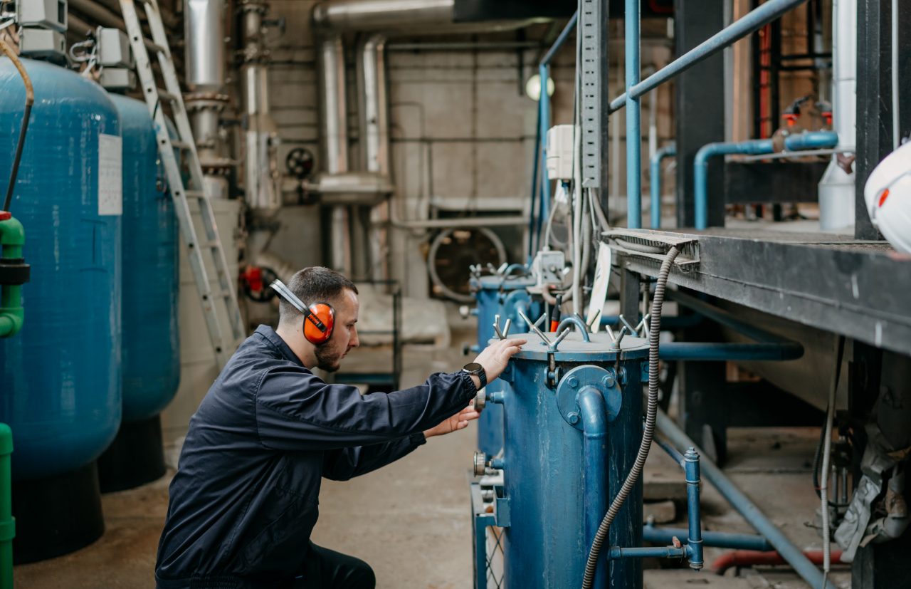 Man checking industrial boiler