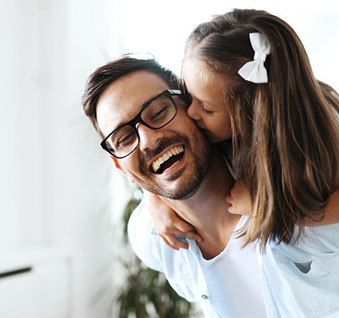 father with daughter on back