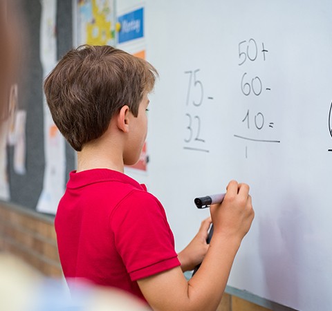 child drawing on whiteboard