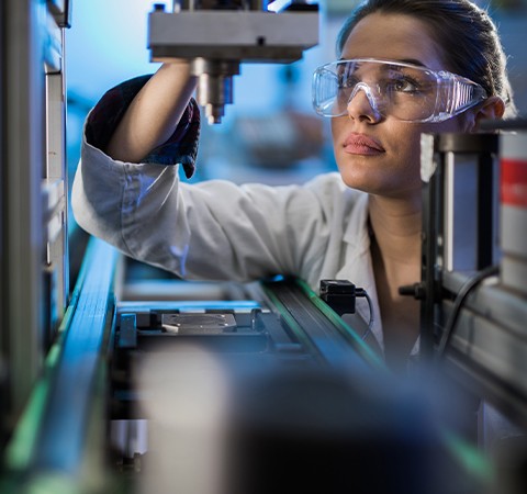 engineer examining machine production line