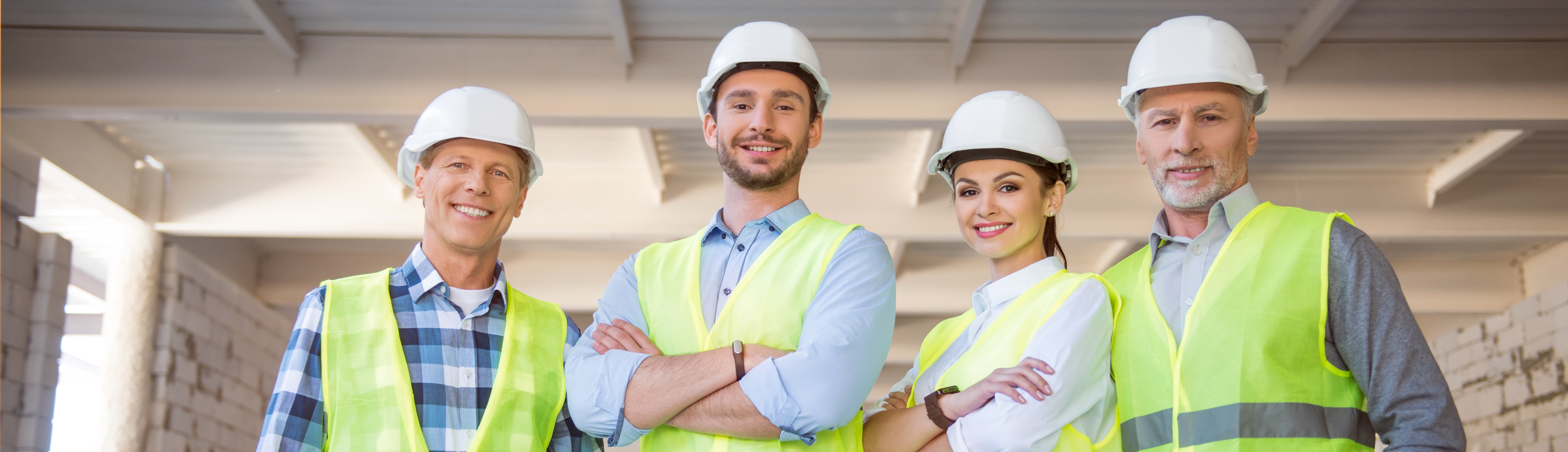 Builders standing and reviewing a construction site plan