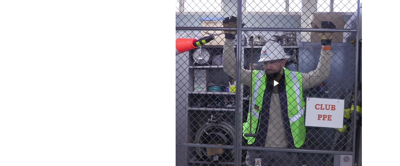 lineman leaning on a fence