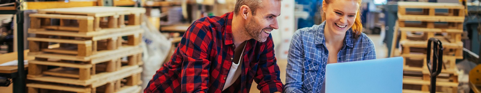 man and woman working on laptop together