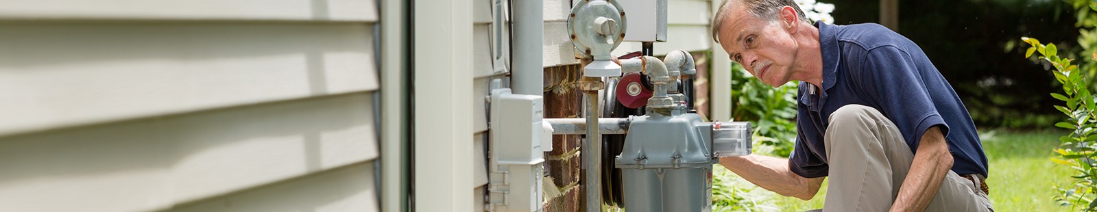 home inspector examines residential gas meter