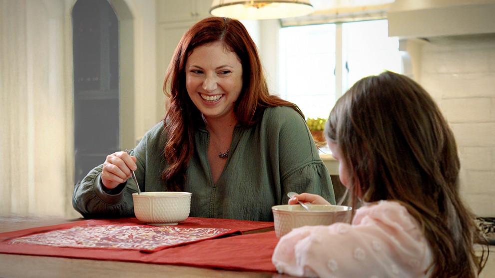 mother and daughter eating breakfast