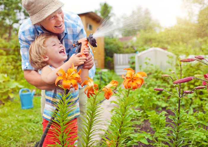 Grandfather and Grandson watering flowers