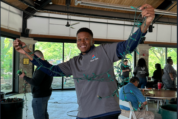 volunteer holding Christmas lights