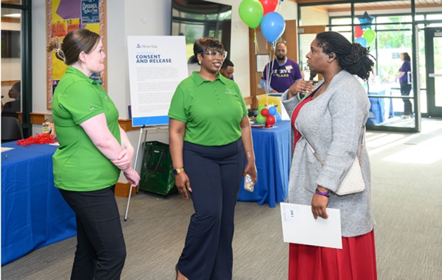 Customer talking to Employees at Event