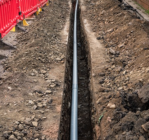 trench dug in street for pipe