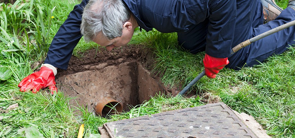 man unblocking drain