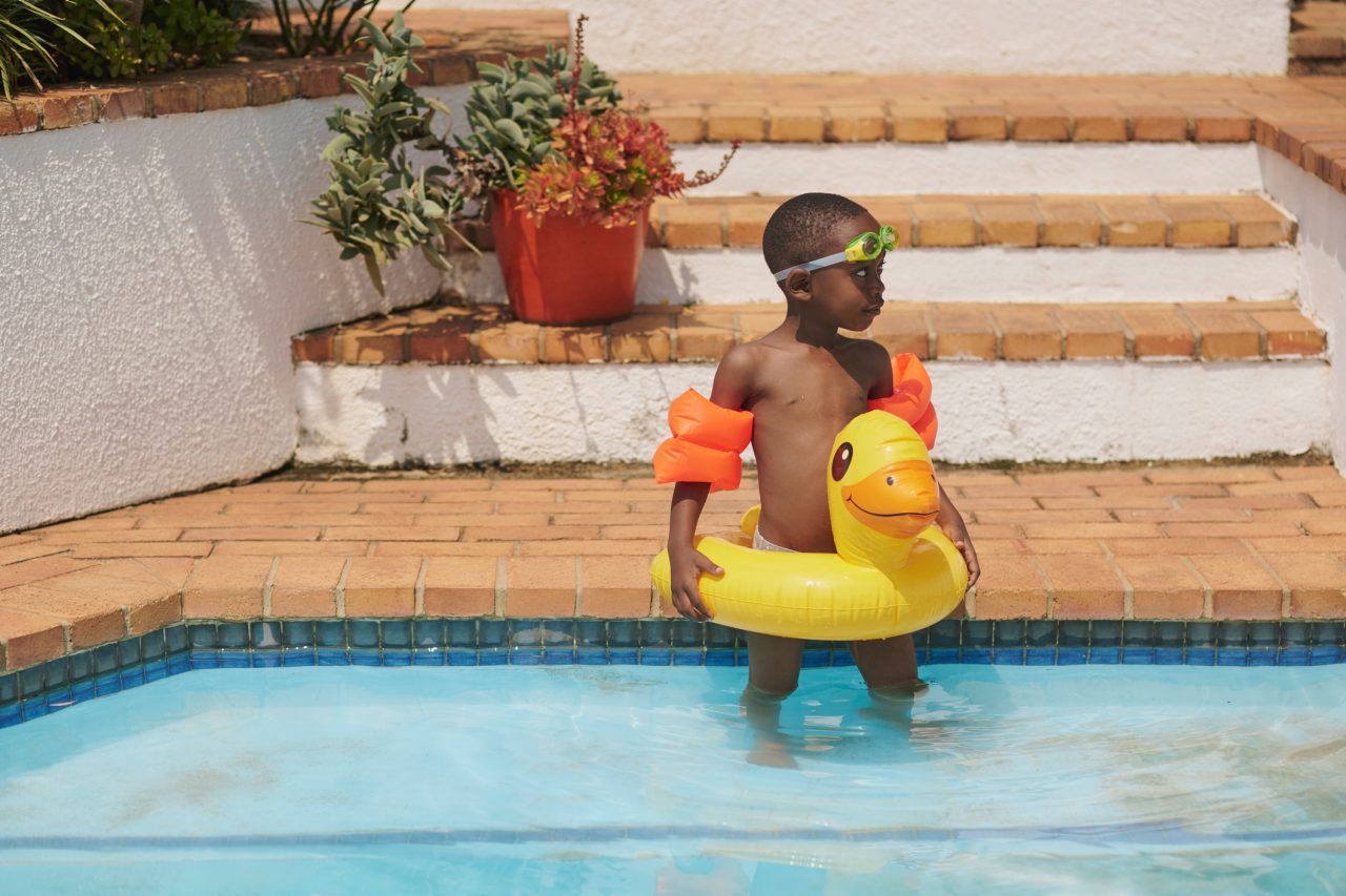 Child by swimming pool